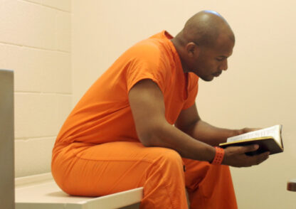 Studying Bible in prison